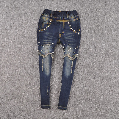 Blugi moderni pentru copii pentru o fată cu perle decorative într-o culoare închisă