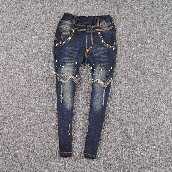 Blugi moderni pentru copii pentru o fată cu perle decorative într-o culoare închisă