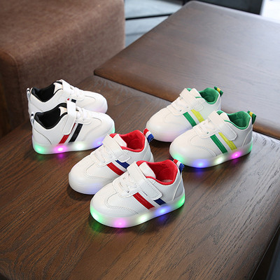 Children`s sneakers for boys with a luminous sole