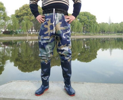 Men`s trousers set with rubber boots suitable for fishing in camouflage pattern