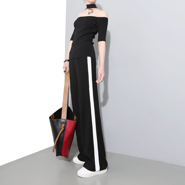 Női alkalmi nadrág fekete színben, oldalpánttal