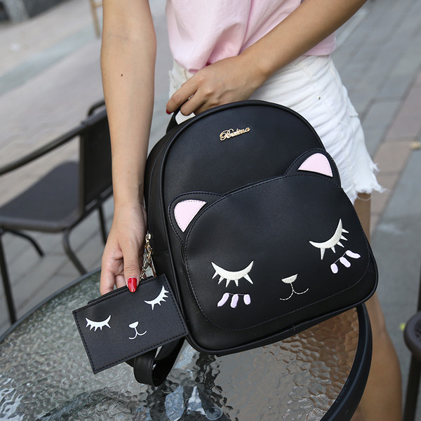 Rucsac de damă negru cu broderie și o geantă mică de voiaj