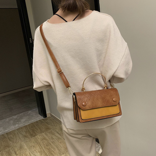 Öt színben fém fogantyúval készült modern női táska öko bőrből