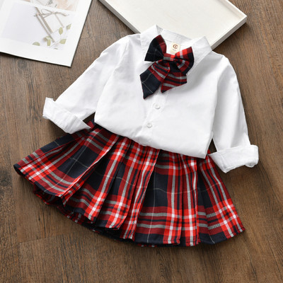 Модерен детски костюм от карирана пола и риза в бял цвят с панделка