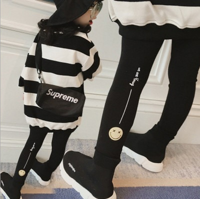 Modern children`s leggings with a print in black and gray