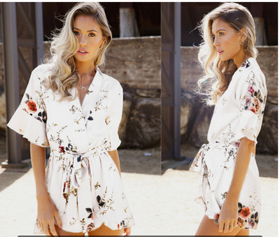 Modern women`s summer overalls with floral motifs in white
