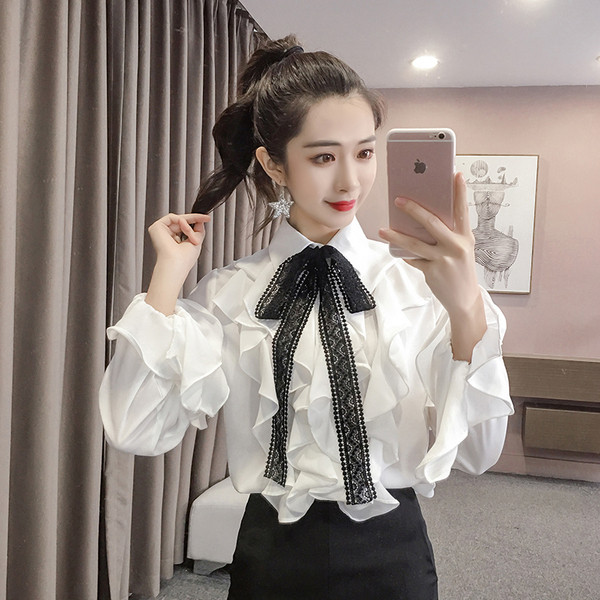 Modern női ing fehér színben, hosszú ujjal és szalaggal