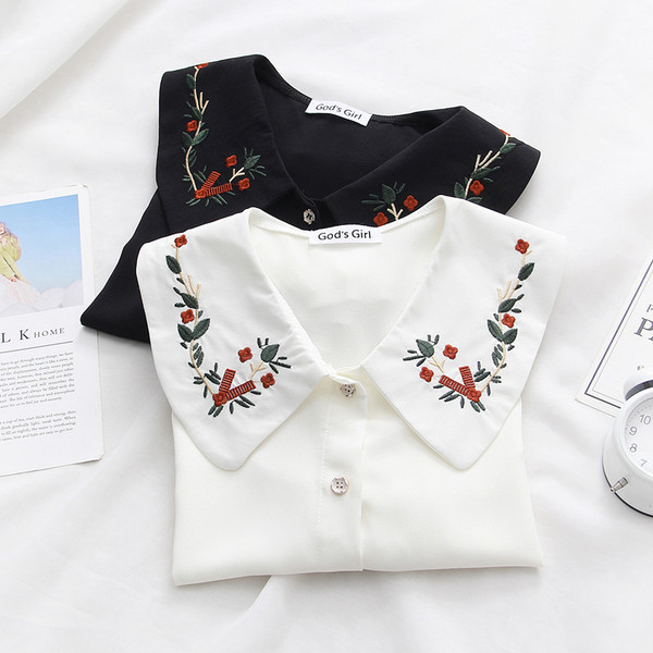 A modern női ing fehér és fekete színű, hímzéssel