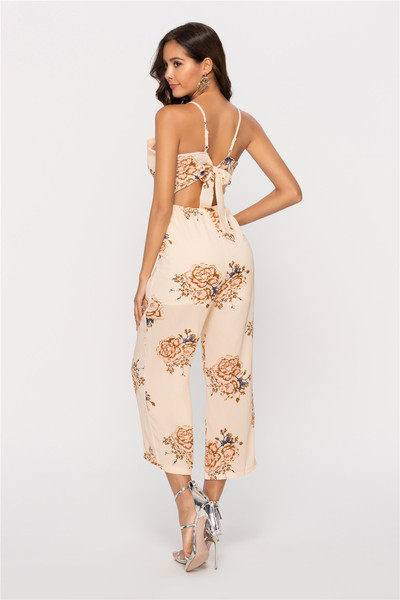 Stílusos női jumpsuit mély V-nyakkal és bézs színű virágmotívumokkal