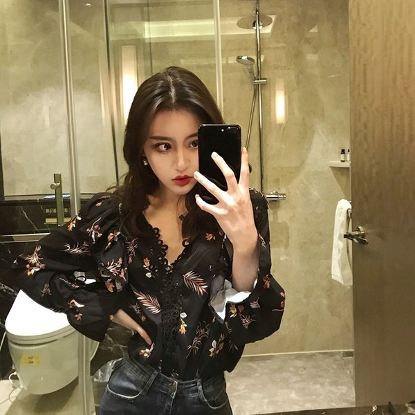 Modern női ing fehér és fekete színben, V-nyakkal és virágmotívumokkal