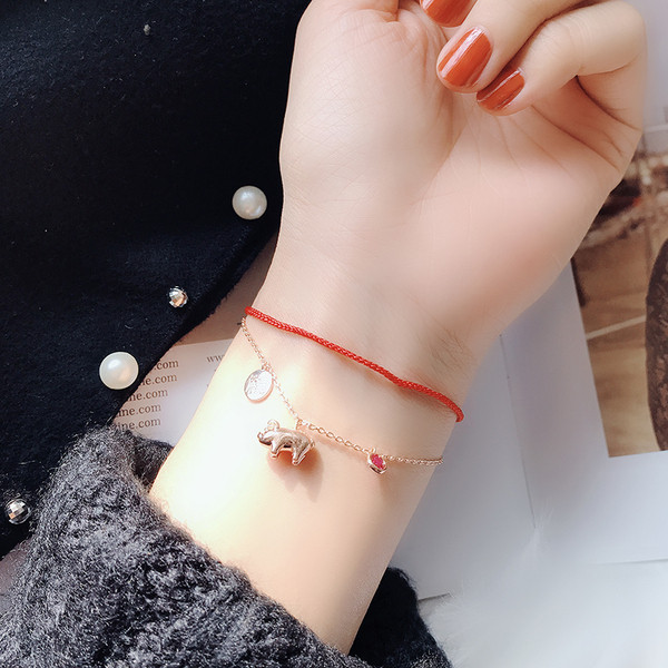 Piros és arany színű női karkötő függőkkel