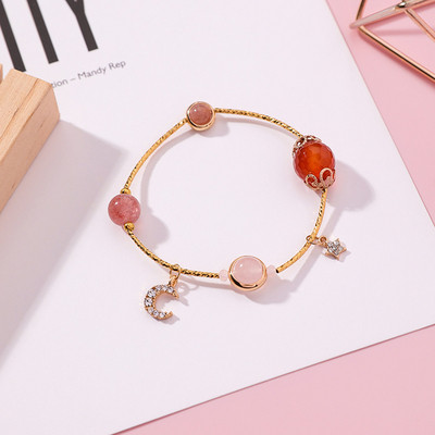 Modern női karkötő gyöngyökkel és medállal két színben