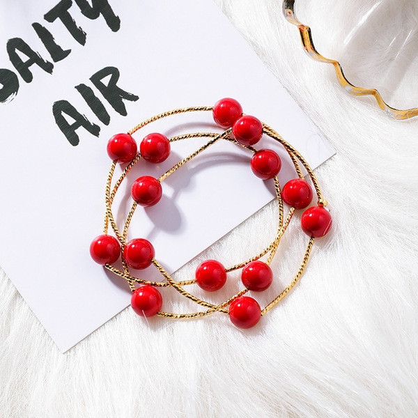 Modern női karkötő piros gyöngyökkel