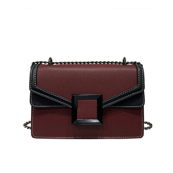 Korszerű női táska fém elemmel, hosszú füllel