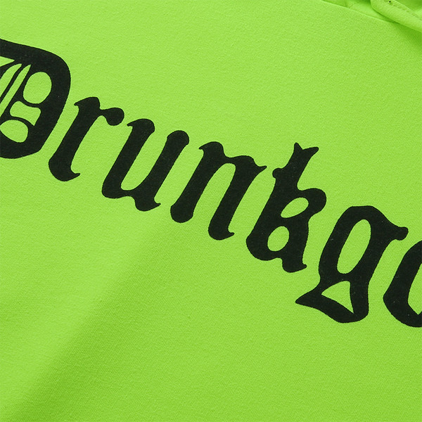 Hosszú, zöld színű női pulóver felirattal és zsebbel