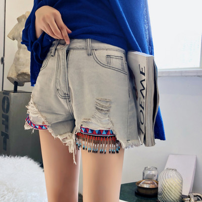 Модерни дамски къси дънкови панталони в светъл цвят и накъсани мотиви