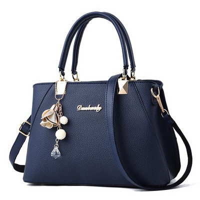 Modern women`s bag made of eco leather in several colors with decoration