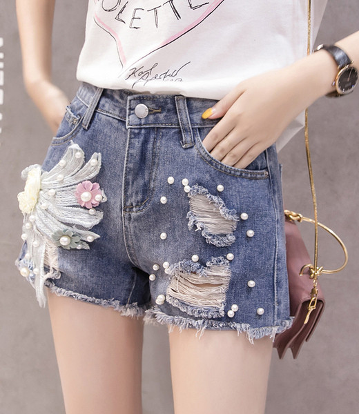 Modern női nadrág gyöngyökkel és 3D elemmel