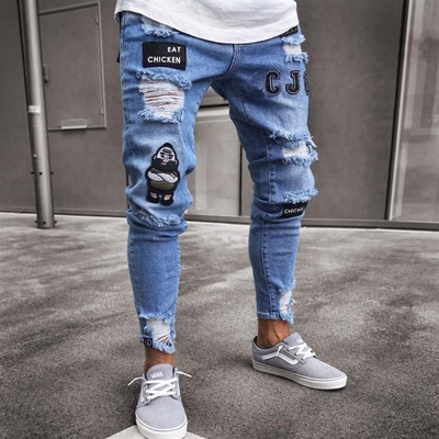 Modern men`s jeans with torn motifs and emblems in blue and white