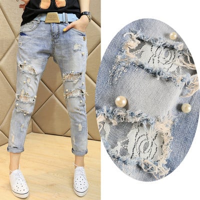 New model of women`s jeans with torn motifs