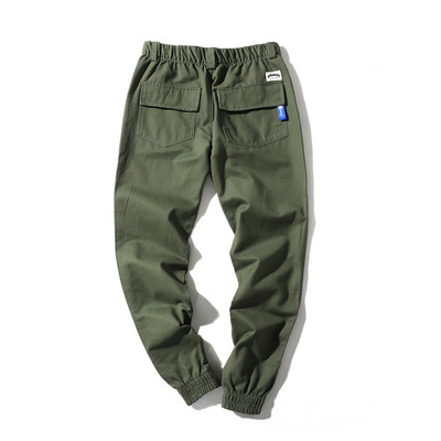 Fashionable men`s pants in four colors with emblems and pockets