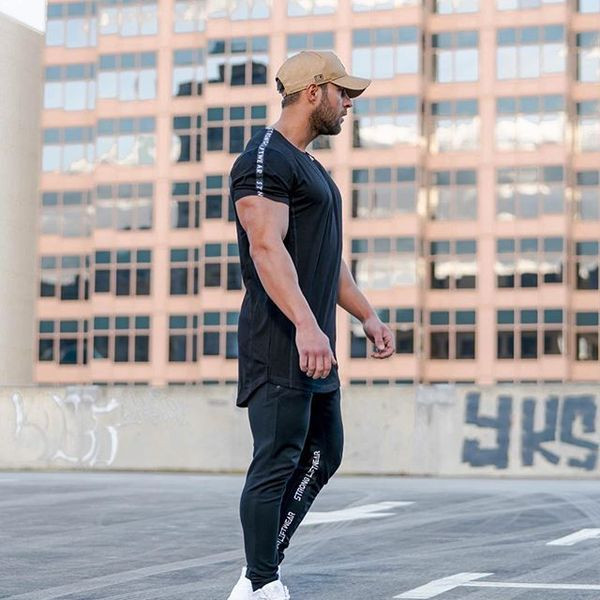 Modern férfi sportnadrág fekete és szürke feliratokkal