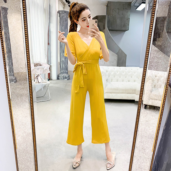 Stílusos női overall, fényes hatású fekete és sárga színben