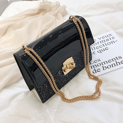 Stílusos női táska fényes elemekkel három színben fém csattal és hosszú fém fogantyúval