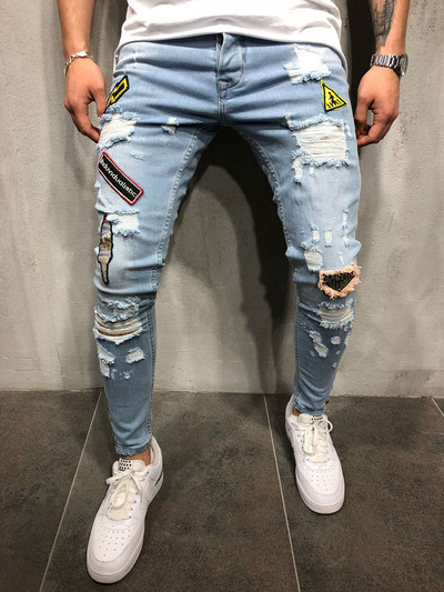 Modern men`s jeans with torn motifs and emblems