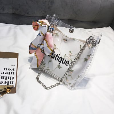Μοντέρνα γυναικεία τσάντα με διαφανές κάλυμμα και κεντήματα σε τρία χρώματα με μεγάλη μεταλλική αλυσίδα
