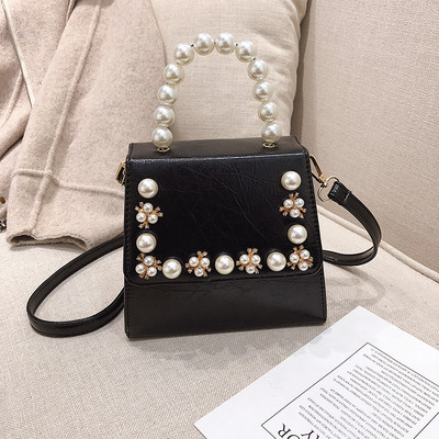 Κομψή γυναικεία τσάντα σε τέσσερα χρώματα με διακοσμητικά μαργαριτάρια και μακρά λαβή