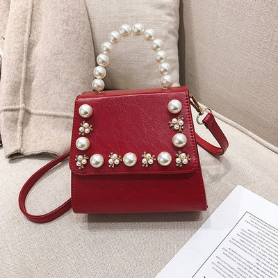 Κομψή γυναικεία τσάντα σε τέσσερα χρώματα με διακοσμητικά μαργαριτάρια και μακρά λαβή