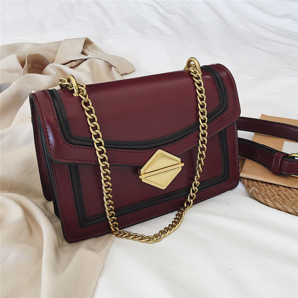 Stílusos női táska három színben fém csattal és hosszú fém fogantyúval