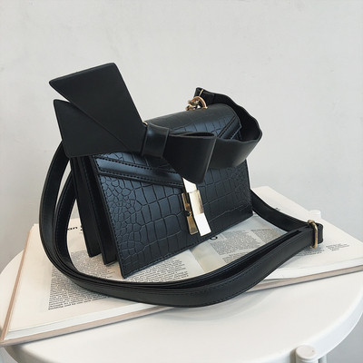 Κομψή γυναικεία τσάντα  σε πέντε χρώματα οικολογικού δέρμα με μεταλλικό κούμπομα και κορδέλα