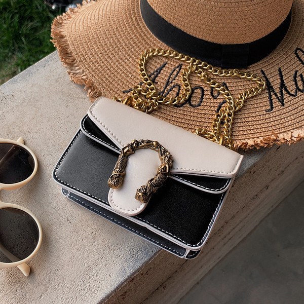 Geanta de dama eleganta in patru culori din piele ecologica cu decor metalic 3D si lant metalic lung