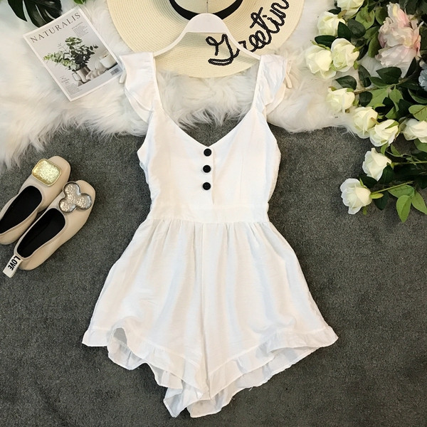 Salopetă de damă modernă cu elemente cu nasturi în alb și negru