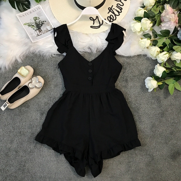 Salopetă de damă modernă cu elemente cu nasturi în alb și negru