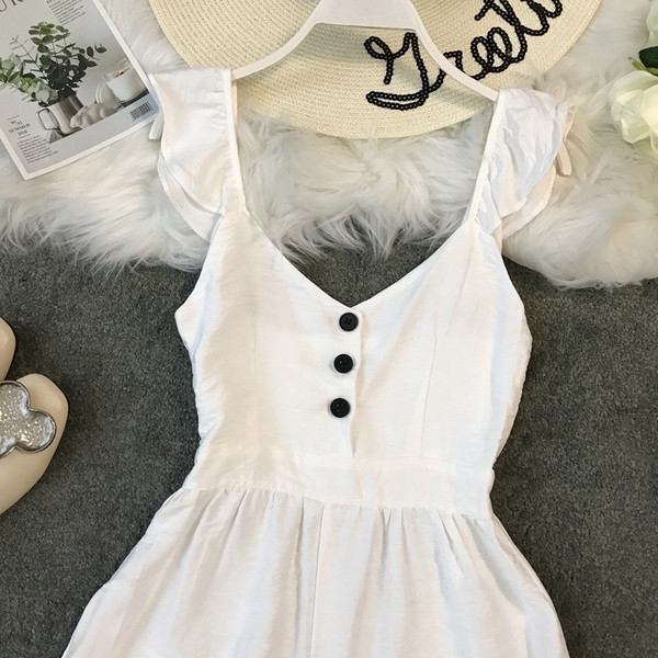 Salopetă de damă modernă cu elemente cu nasturi în alb și negru