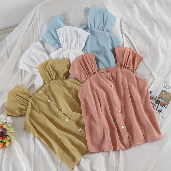 Modern női felső több színben, gombokkal és széles pántokkal