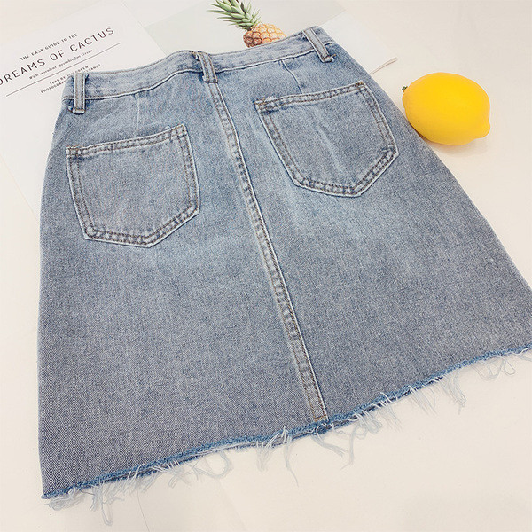 Modern női farmerszoknya szakadt motívumokkal