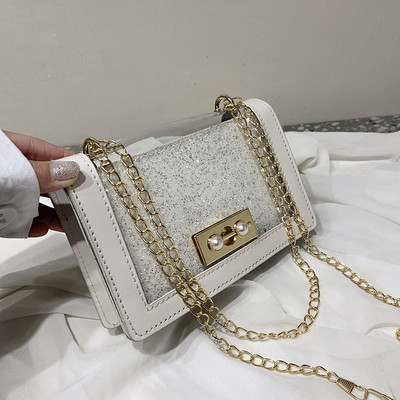 Stílusos női táska fényes hatású fém fogantyúval több színben