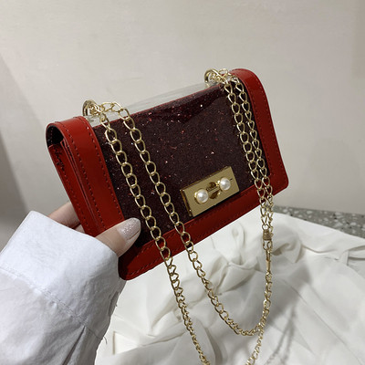 Stílusos női táska fényes hatású fém fogantyúval több színben