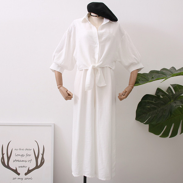 Modern női overall 3/4-es ujjakkal és gombokkal