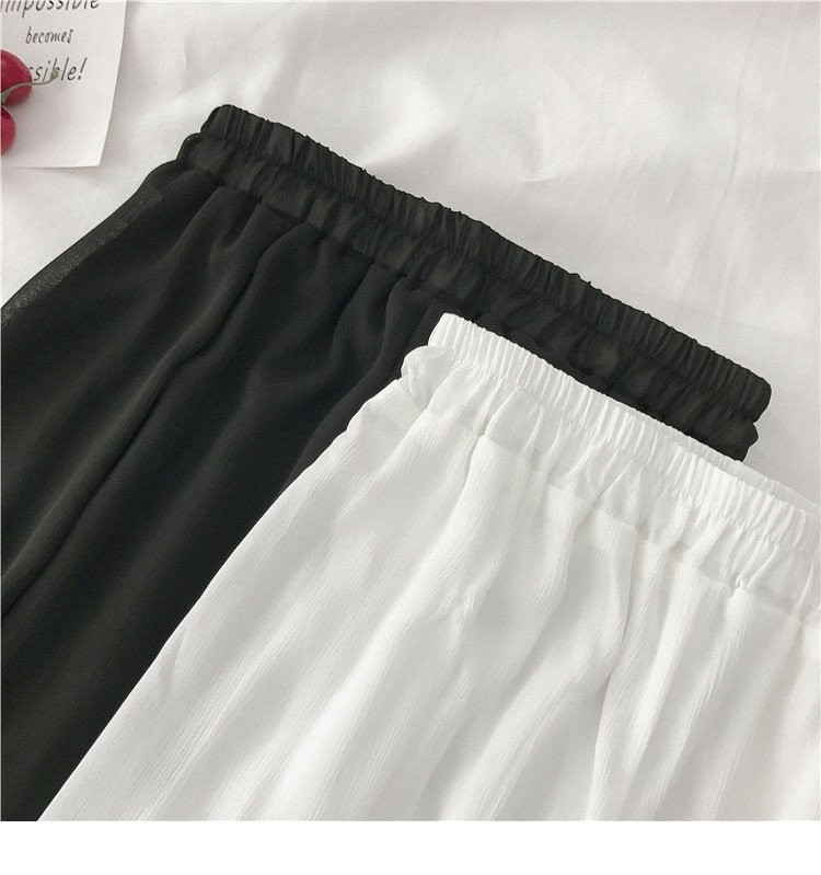 Női széles modellnadrág fehér és fekete színben