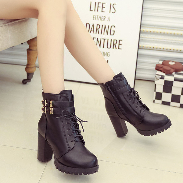 Υπέροχες γυναικείες ζεστές μπότες με ένα λουρί και μια τραχιά χαλάρωση σε μαύρο χρώμα