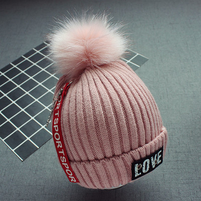 Стилна плетена детска шапка в няколко цвята с надписи и пухче