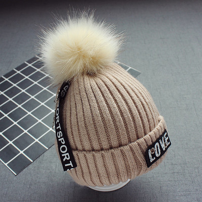 Стилна плетена детска шапка в няколко цвята с надписи и пухче