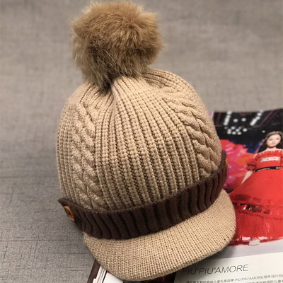 Зимна детска шапка с козирка и пухче в няколко цвята