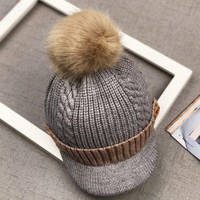 Зимна детска шапка с козирка и пухче в няколко цвята