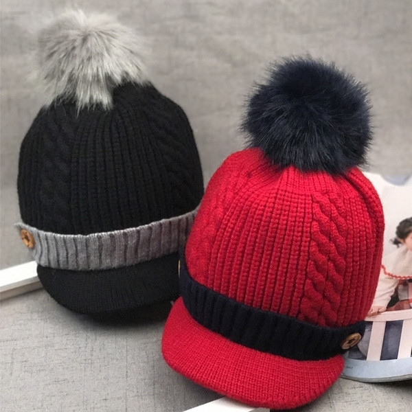 Зимна детска шапка с козирка и пухче в няколко цвята